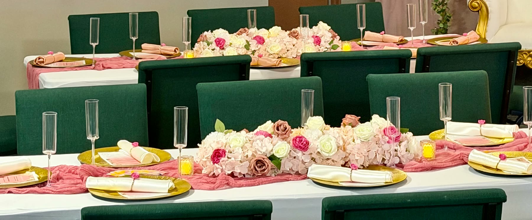 Long banquet tablescape with pink runners, gold chargers and blush floral centerpieces